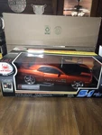 New Bright Dodge Challenger R/t 49 Mhz Orange 9.6V Remote Control Car 1:10 Scale. Fixed Price $150.00.